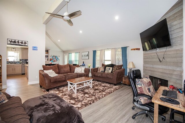 6203 Wickwillow Ln, Alvin, TX 77511 - living area featuring light wood finished floors, high vaulted ceiling, a fireplace, a ceiling fan, and recessed lighting