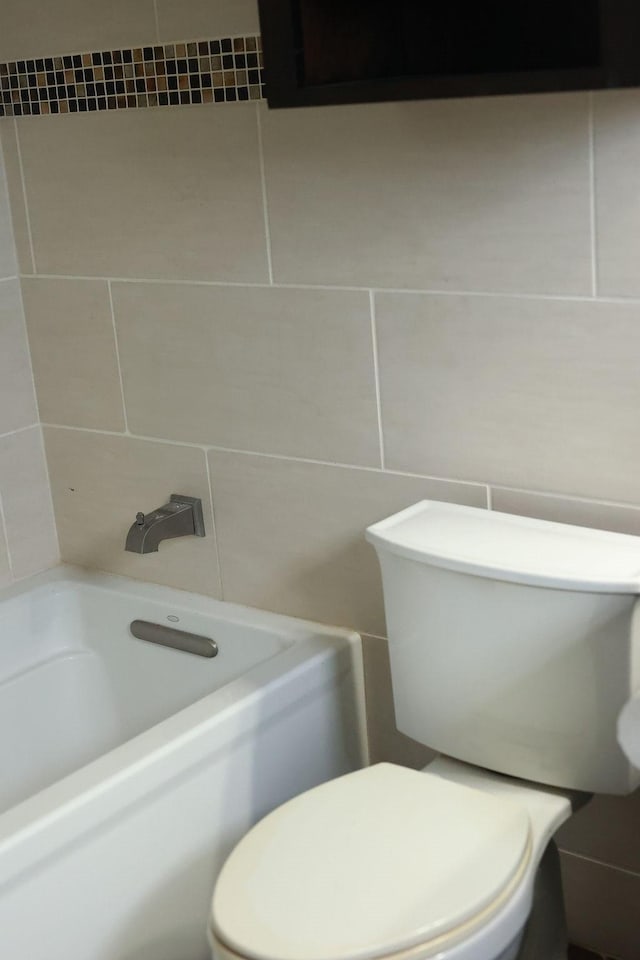 1620 Wellington Pl Unit 204, Beaumont, TX 77706 - full bathroom featuring a bathtub, tile walls, and a shower