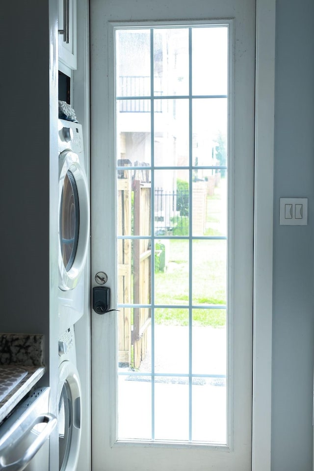 1620 Wellington Pl Unit 204, Beaumont, TX 77706 - laundry area featuring stacked washer / drying machine and plenty of natural light