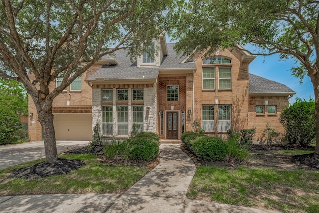 16011 Maple Shores Dr, Houston, TX 77044 - view of front of home featuring driveway, a shingled roof, a garage, and brick siding