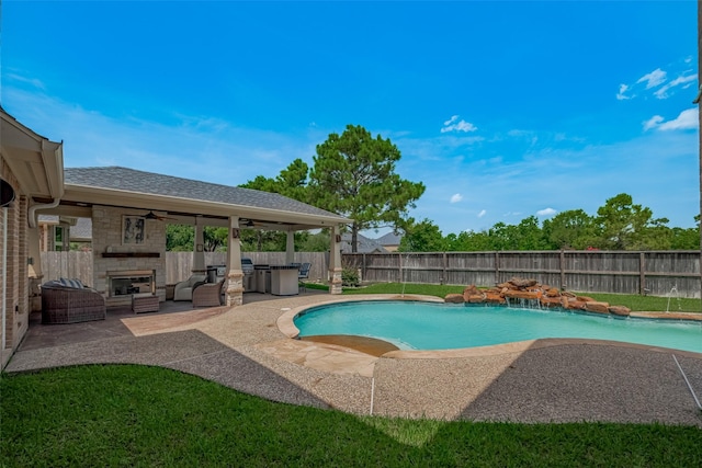 16011 Maple Shores Dr, Houston, TX 77044 - view of swimming pool with a fenced backyard, a patio, a ceiling fan, and an outdoor living space with a fireplace