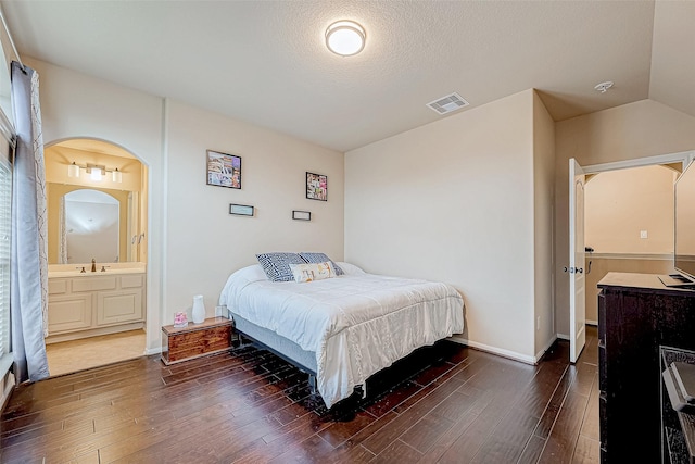 16011 Maple Shores Dr, Houston, TX 77044 - bedroom with wood finished floors, ensuite bath, and a textured ceiling