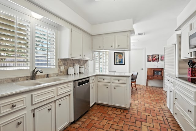 2618 Fontana Dr, Houston, TX 77043 - kitchen with stainless steel appliances, decorative backsplash, light countertops, and brick floors