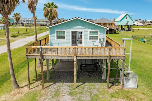 430 Jettyview Rd, Surfside Beach, TX 77541 - rear view of house with a deck, a carport, and dirt driveway