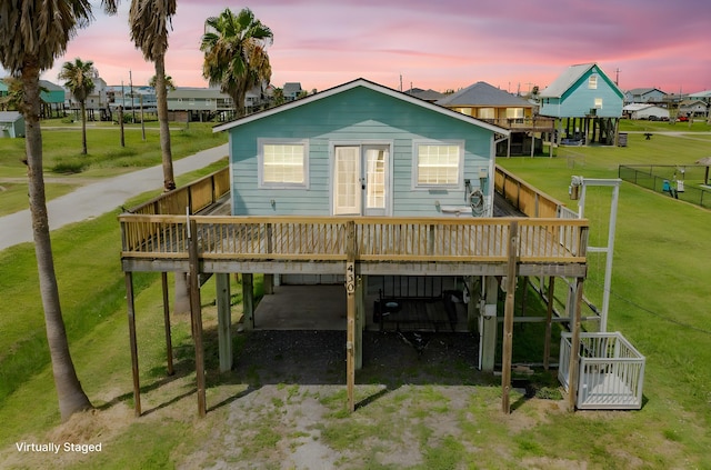 430 Jettyview Rd, Surfside Beach, TX 77541 - back of house featuring a deck, a carport, and dirt driveway