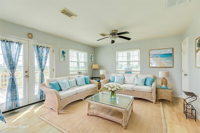 430 Jettyview Rd, Surfside Beach, TX 77541 - living room with light wood-style flooring, french doors, and a ceiling fan