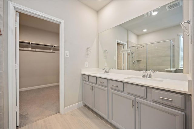 4427 Silvergrass Ln, Katy, TX 77493 - full bathroom with a walk in closet, a stall shower, and double vanity