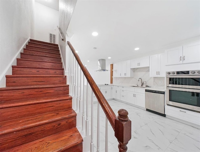 1691 W Sam Houston Pkwy S, Houston, TX 77042 - stairs with marble look tiles and recessed lighting