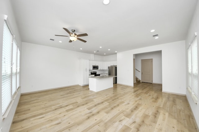 2119 Esther Dr, Houston, TX 77088 - unfurnished living room with recessed lighting, ceiling fan, and light wood-style floors