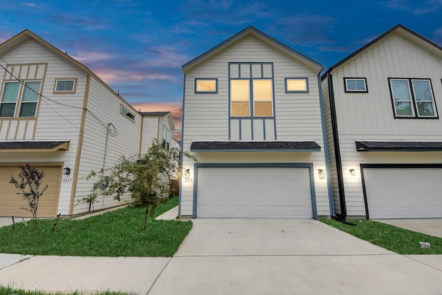 2119 Esther Dr, Houston, TX 77088 - view of front of property with an attached garage, board and batten siding, and driveway