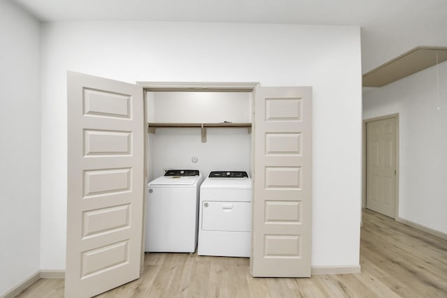 2119 Esther Dr, Houston, TX 77088 - laundry room featuring separate washer and dryer and light wood-style flooring