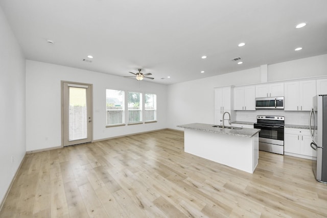 2119 Esther Dr, Houston, TX 77088 - kitchen featuring appliances with stainless steel finishes, ceiling fan, tasteful backsplash, light stone countertops, and recessed lighting
