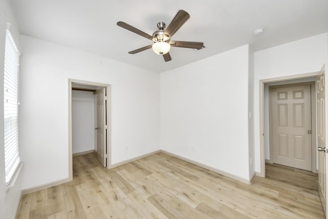 2119 Esther Dr, Houston, TX 77088 - unfurnished bedroom featuring light wood-style floors, a walk in closet, a ceiling fan, and a closet
