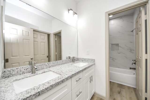 2119 Esther Dr, Houston, TX 77088 - bathroom featuring double vanity, wood finished floors, and shower / tub combination