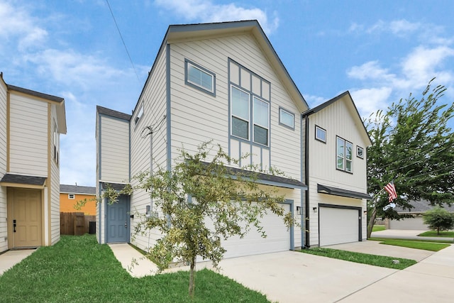 2119 Esther Dr, Houston, TX 77088 - view of front of home featuring an attached garage, concrete driveway, and board and batten siding
