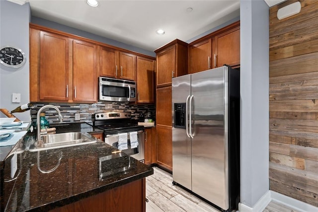 3001 Murworth Dr Unit 1603, Houston, TX 77025 - kitchen with appliances with stainless steel finishes, dark stone counters, brown cabinetry, light wood-style floors, and recessed lighting