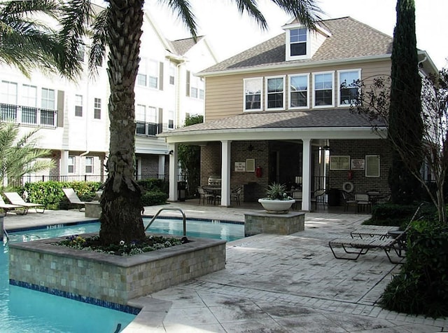 3001 Murworth Dr Unit 1603, Houston, TX 77025 - back of property with a patio, a community pool, roof with shingles, and brick siding