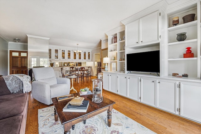 2238 S Piney Point Rd Unit 204, Houston, TX 77063 - living area featuring a chandelier, crown molding, and light wood finished floors