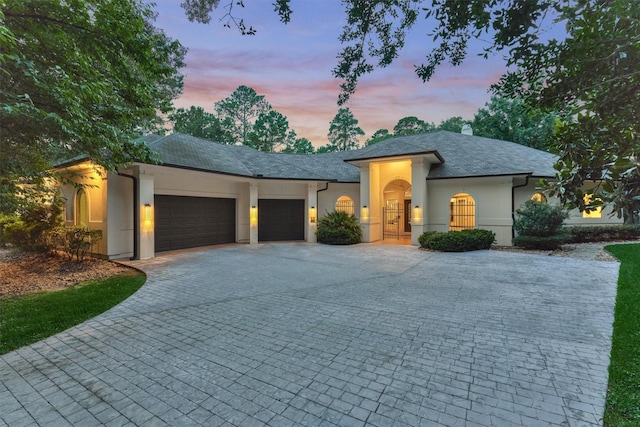 134 Trinity Oaks Ct, The Woodlands, TX 77381 - view of front of home featuring decorative driveway, an attached garage, and stucco siding