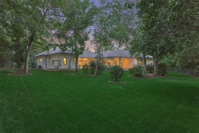 134 Trinity Oaks Ct, The Woodlands, TX 77381 - view of front of house featuring a lawn and stucco siding