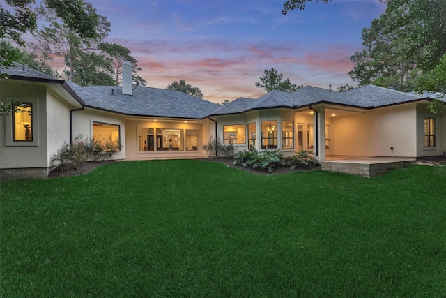 134 Trinity Oaks Ct, The Woodlands, TX 77381 - back of property with a chimney, stucco siding, and a yard