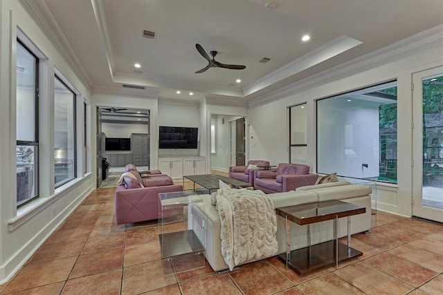 134 Trinity Oaks Ct, The Woodlands, TX 77381 - living area with a tray ceiling, crown molding, a ceiling fan, and light tile patterned floors