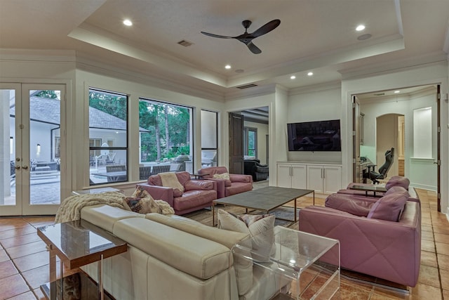 134 Trinity Oaks Ct, The Woodlands, TX 77381 - living area featuring a raised ceiling, a ceiling fan, french doors, plenty of natural light, and crown molding