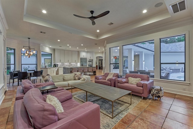 134 Trinity Oaks Ct, The Woodlands, TX 77381 - living room with a tray ceiling, crown molding, a chandelier, ceiling fan, and recessed lighting