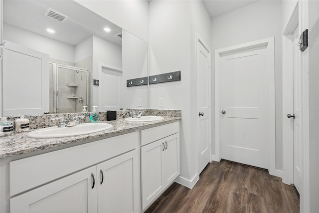 16934 Needlepoint Dr, Conroe, TX 77302 - full bath with a stall shower, double vanity, wood finished floors, and recessed lighting