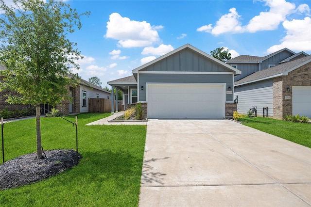 16934 Needlepoint Dr, Conroe, TX 77302 - view of front of home with a garage, board and batten siding, a front lawn, concrete driveway, and brick siding