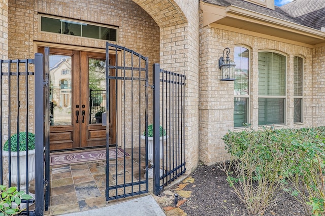 24115 Porte Toscana Ln, Richmond, TX 77406 - doorway to property featuring a gate, a shingled roof, and french doors