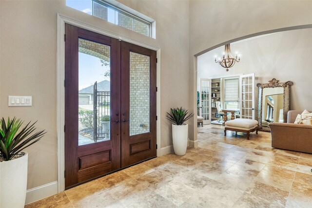 24115 Porte Toscana Ln, Richmond, TX 77406 - foyer entrance with french doors, a chandelier, and a towering ceiling