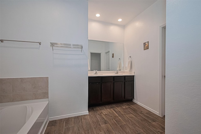 22618 Cremona Village Trl, Katy, TX 77449 - full bath with double vanity, wood finished floors, a bath, and recessed lighting