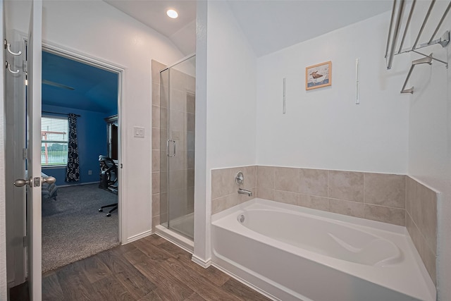 22618 Cremona Village Trl, Katy, TX 77449 - bathroom with a bath, wood finished floors, ensuite bathroom, a stall shower, and lofted ceiling