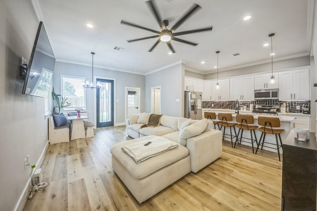 6524 Couch St, Houston, TX 77091 - living area with recessed lighting, a ceiling fan, light wood-style flooring, a chandelier, and ornamental molding