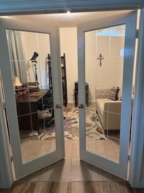 7126 Grants Hollow Ln, Richmond, TX 77407 - doorway to outside featuring french doors and wood finished floors