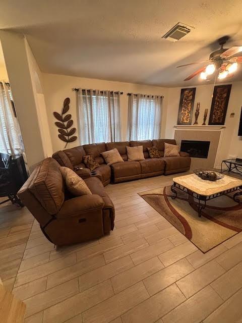 7126 Grants Hollow Ln, Richmond, TX 77407 - living area with a ceiling fan and a fireplace