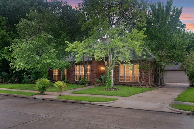 11603 Orchard Mountain Dr, Houston, TX 77059 - obstructed view of property with brick siding, a lawn, a garage, and concrete driveway