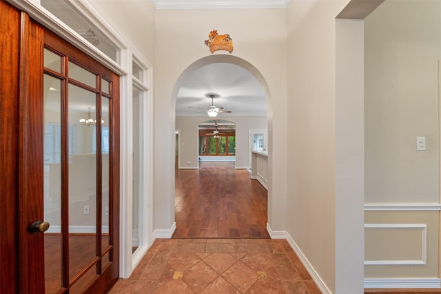 11603 Orchard Mountain Dr, Houston, TX 77059 - hallway featuring arched walkways, ornamental molding, and stone finish floors