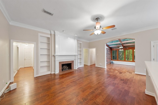 11603 Orchard Mountain Dr, Houston, TX 77059 - unfurnished living room with ceiling fan, hardwood / wood-style floors, built in features, a tiled fireplace, and crown molding