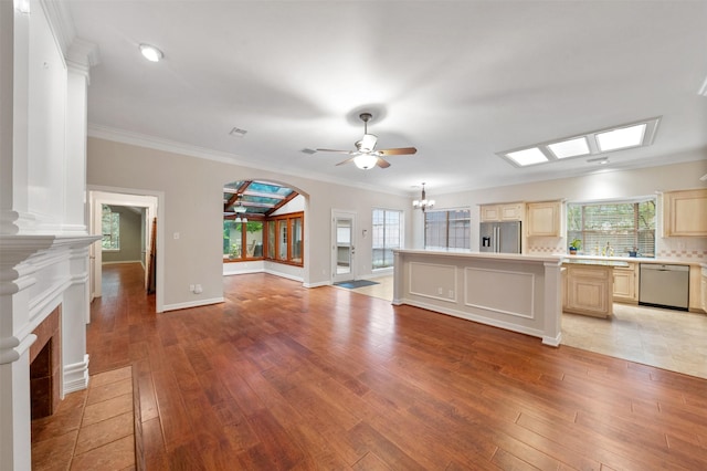 11603 Orchard Mountain Dr, Houston, TX 77059 - unfurnished living room with ceiling fan, light wood-style floors, a fireplace, arched walkways, and crown molding