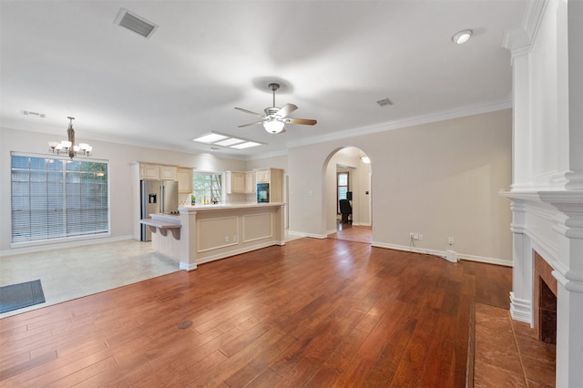 11603 Orchard Mountain Dr, Houston, TX 77059 - unfurnished living room with a ceiling fan, arched walkways, a chandelier, wood finished floors, and plenty of natural light