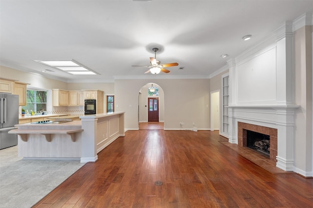 11603 Orchard Mountain Dr, Houston, TX 77059 - kitchen with freestanding refrigerator, open floor plan, light countertops, hardwood / wood-style floors, and a tile fireplace