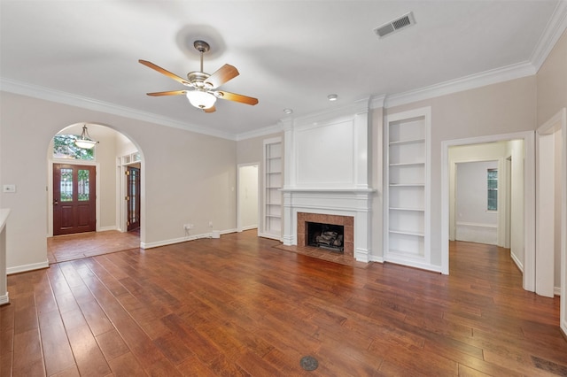 11603 Orchard Mountain Dr, Houston, TX 77059 - unfurnished living room with arched walkways, ceiling fan, dark wood-style floors, built in features, and crown molding