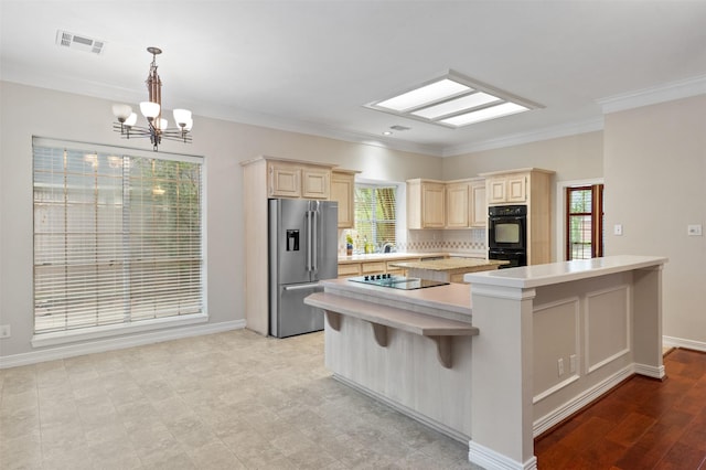 11603 Orchard Mountain Dr, Houston, TX 77059 - kitchen with black appliances, light countertops, a kitchen island, a chandelier, and healthy amount of natural light