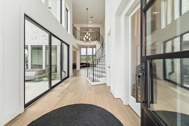 15714 Park Poetry Ct, Cypress, TX 77433 - hallway with wood finished floors, stairs, a chandelier, and a high ceiling