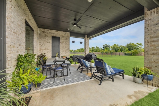 15714 Park Poetry Ct, Cypress, TX 77433 - fenced backyard with outdoor dining area, ceiling fan, a patio area, and a grill