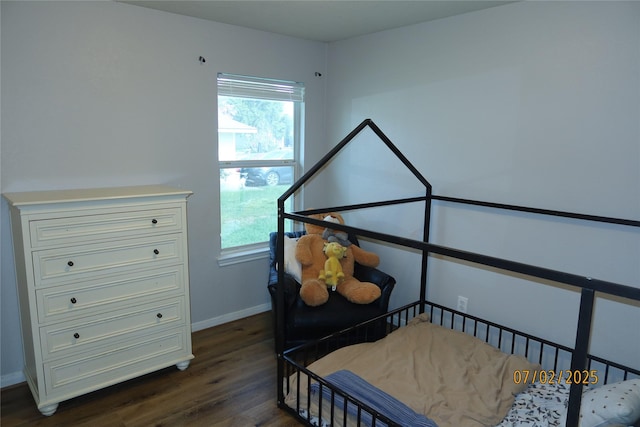 305 Duprie Dr, Brenham, TX 77833 - bedroom featuring dark wood-type flooring and multiple windows