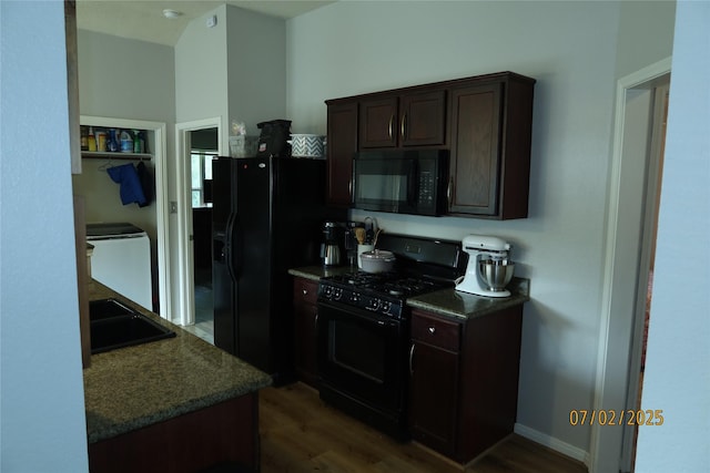305 Duprie Dr, Brenham, TX 77833 - kitchen with black appliances, washer / dryer, dark wood finished floors, and dark brown cabinets