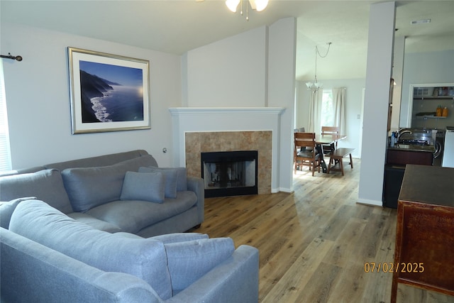 305 Duprie Dr, Brenham, TX 77833 - living area featuring wood finished floors, lofted ceiling, a ceiling fan, and a fireplace